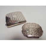 A hallmarked silver cigarette case and a ladies white metal compact