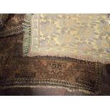 Old brown patterned Persian rug, worn,