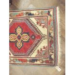 Red and patterned Persian style carpet runner - 9' 6 X 2'5
