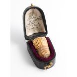An hallmarked 9ct gold thimble in fitted box by J W Long & Co Cardiff thimble weighs 5.