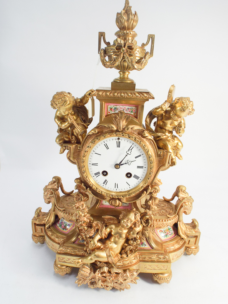 19th century striking French mantel clock in gilded ormolu case decorated with cherubs and pink