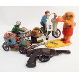A collection of 8 old tine plate toys to include a boxing monkey, speedway rider,