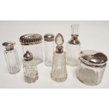 A collection of cut glass dressing table jars 4 with silver tops,