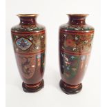 A pair of quality Japanese Cloisonne enamel vases with an iron red ground on circular hardwood vase