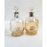 A pair of lustre amber glass dimpled decanters with silver collars hallmarked for London 1894,