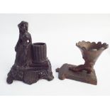 Two novelty cast iron table vestas, one modelled as a shoe,