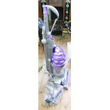 Mauve and silver upright vacuum cleaner