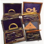 Four mahogany and rosewood boxed technical drawing sets complete with compasses, rulers,