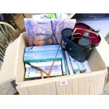 Box of books on birds and bird watching and a pair of binoculars in carry case