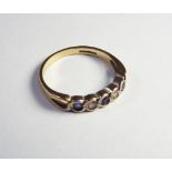 9ct gold sapphire and stone set half hoop ring.