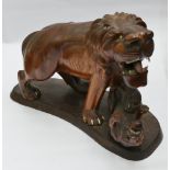 Carved hardwood lion fighting a leopard