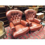 A pair of brown buttoned leather upholstered easy chairs