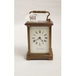 A brass carriage clock by W Burford & Sons Ltd of Exeter and Eastbourne glass panel to top,