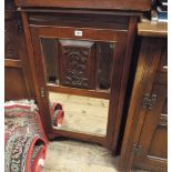 An Edwardian walnut music cabinet with mirrored door