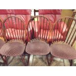 Set of four stick back windsor dining chairs with upholstered seats