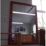 A large pine framed mirror