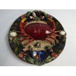 Large Portuguese Pallisy style plate decorated in relief with a crab amongst seafood,