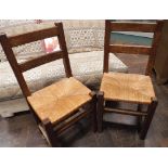 Pair of oak ladder back rush seat dining chairs