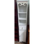 A white tall bathroom cabinet with cupboard under,