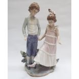 Lladro figure of a young boy and girl in smart dress,