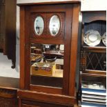 An Edwardian music cabinet with mirrored door