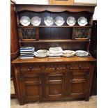 A 4'6 reproduction oak dresser with open shelf and leaded glazed back