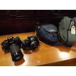 Canon 35mm camera with lens and a Nikon camera with carry cases