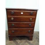 A small Edwardian mahogany chest of 4 long graduated drawers with circular brass drop ring handles