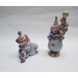 Two Lladro figures of child clowns, one holding a bunch of balloons, the other with a puppy.