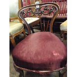 A Victorian walnut framed occasional chair with red upholstered seat