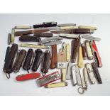A collection of approximately 42 pocket knives to include a few advertising examples and military