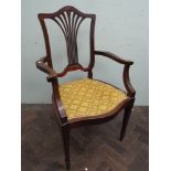 An Edwardian mahogany open arm elbow chair