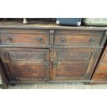 An oak sideboard with 2 cupboards and 2 drawers