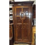 A 2'6 oak hall wardrobe with fielded panel door