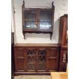 A 4'6 reproduction oak low book case with leaded glazed centre doors and a matching wall fixing 2