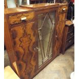 Art Deco walnut cabinet with fitted cupboards and sunburst glazed centre section,