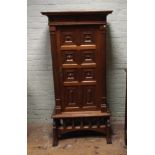 A 2'6 continental walnut cabinet with studded panel door fitted with interior shelves