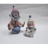 Two Lladro figures of child clowns, one balancing on a ball, the other sat with puppy.