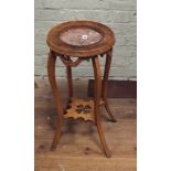 A circular walnut 2 tier plant pedestal with inset rouge marble top