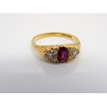 18ct gold ruby and diamond half hoop ring set with an oval ruby flanked each side with 6 brilliant