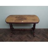 A Victorian walnut stretcher table top measures 115cms long by 56cms wide