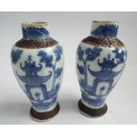 Pair of Oriental blue and white crackle glazed vases with lids decorated with pergodas,