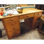 A 4'6 pine pedestal knee hole desk fitted 9 drawers