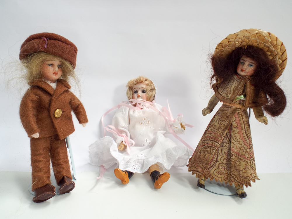 Group of three miniature bisque head dolls