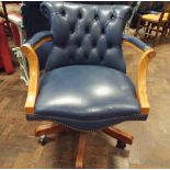 Mahogany framed blue buttoned leather upholstered revolving office elbow chair