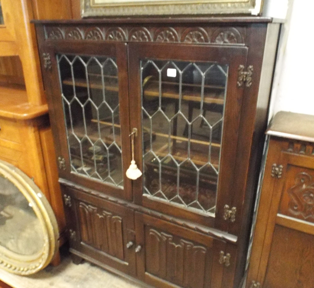 3' reproduction oak leaded glazed 2 door book case with linen fold panels under