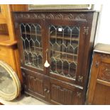 3' reproduction oak leaded glazed 2 door book case with linen fold panels under