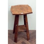 An Arts and Crafts oak 2 tier occasional table with clover leaf cut out panels to the supports