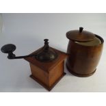 A vintage coffee grinder and a tobacco box and lid