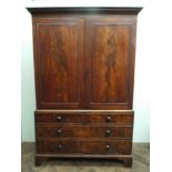 A large Georgian mahogany linen press with 2 cupboard doors fitted 3 sliders with wide base fitted